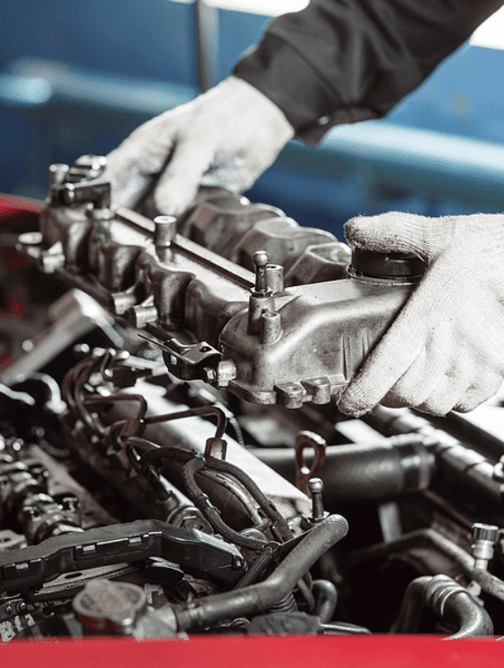 Light-Duty Diesel Services | Kanuga Tire & Auto in Hendersonville, NC. Image of a mechanic's hand repairing a diesle engine. Concept image of diesel maintenance, diesel engine maintenance, and preventative maintenance,