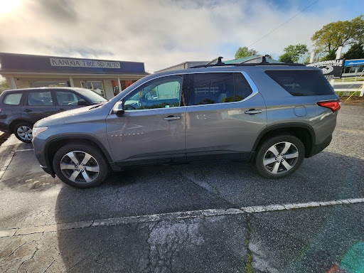 GM certified repair for chevy and gmc vehicles near me in Hendersonville, NC with Kanuga Tire and Auto. Image of newer gray chevy Traverse vehicle parked outside of Kanuga Tire and Auto that came in for certified repair and maintenance.