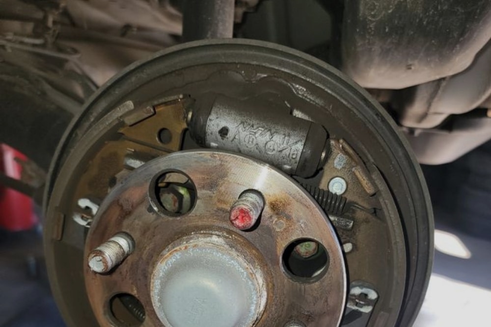 Brake Replacement in Hendersonville, NC At Kanuga Tire & Auto. Close-up of a vehicle brake in an auto repair shop